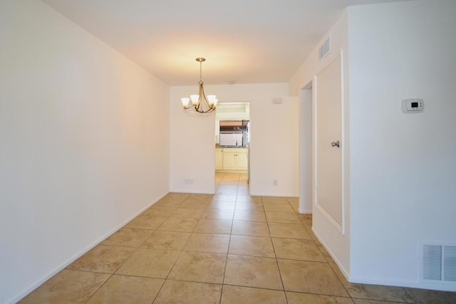 interior space with a notable chandelier and light tile patterned floors