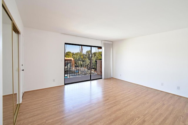 spare room with light hardwood / wood-style flooring