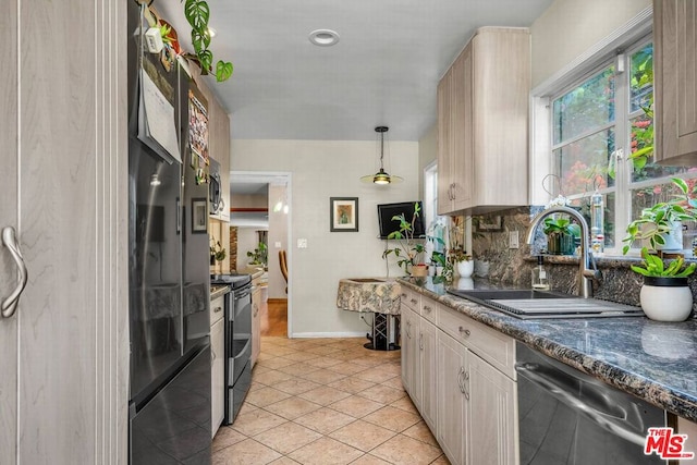 kitchen featuring pendant lighting, light brown cabinetry, dishwasher, sink, and stainless steel range with electric stovetop