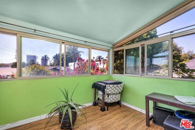 sunroom / solarium featuring vaulted ceiling