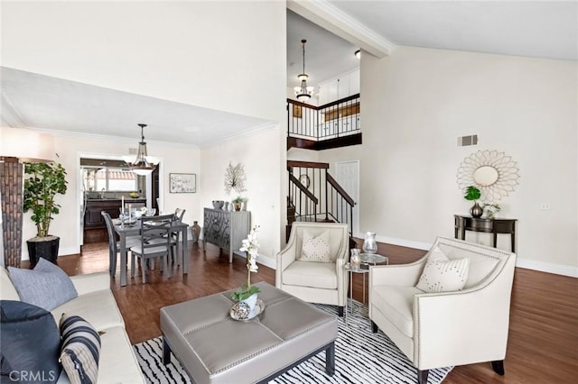 living room featuring an inviting chandelier, hardwood / wood-style floors, high vaulted ceiling, and beamed ceiling