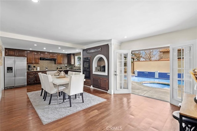 dining room with french doors and light wood-type flooring