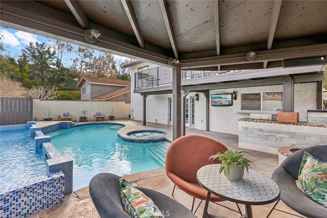 view of swimming pool with an in ground hot tub, pool water feature, and a patio area