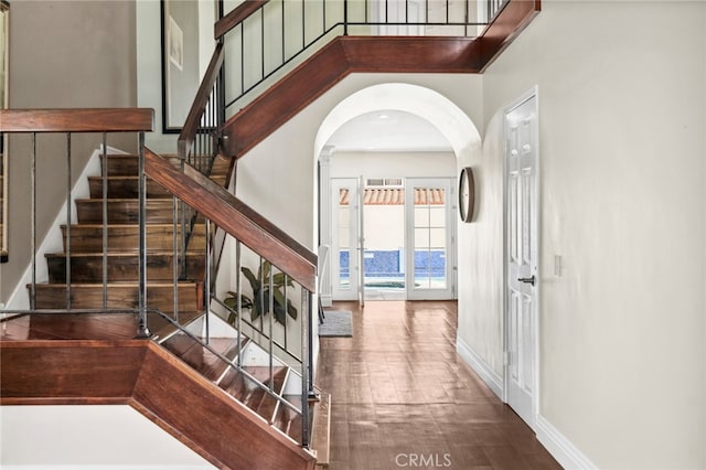 staircase featuring a towering ceiling