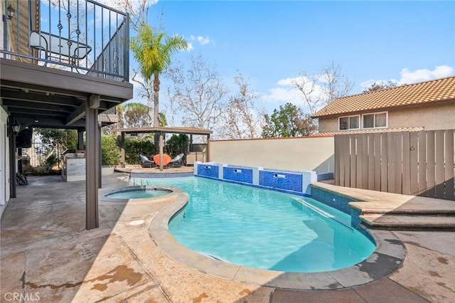 view of swimming pool featuring an in ground hot tub, pool water feature, a patio area, and a gazebo