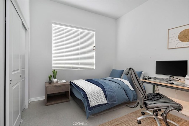 carpeted bedroom with a closet