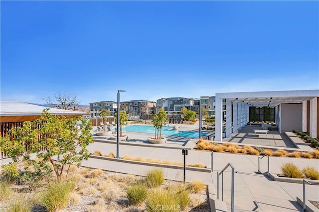 view of pool with a patio and a pergola