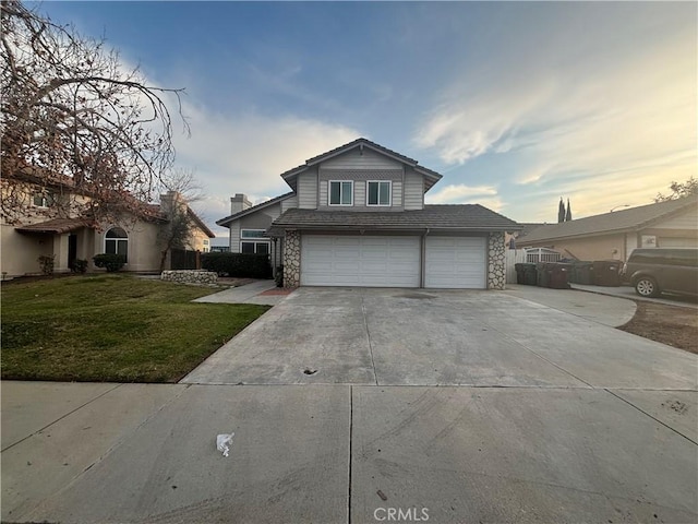 front of property featuring a garage and a lawn