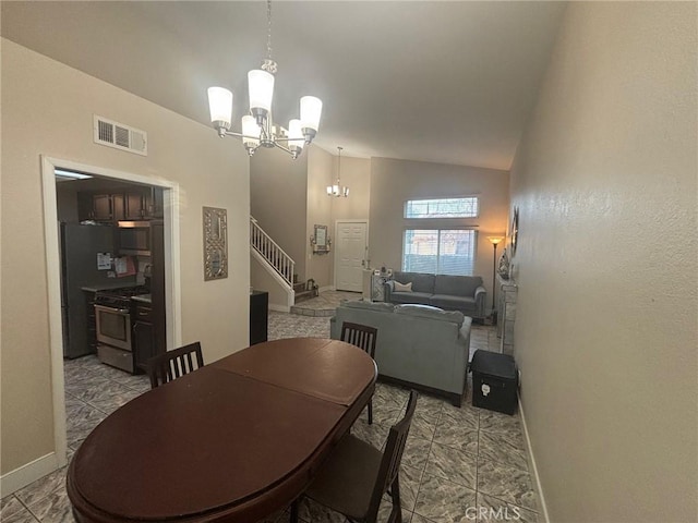 dining room with high vaulted ceiling and a notable chandelier