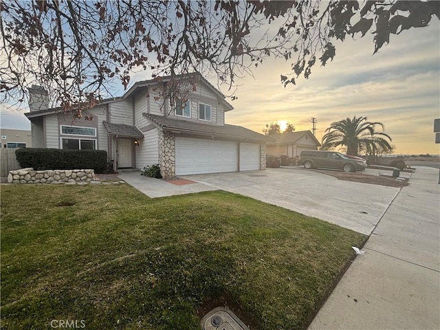 view of front of house with a garage and a lawn