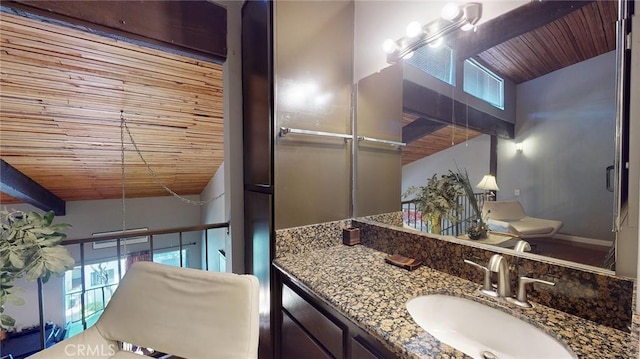 bathroom with wood ceiling, vanity, and toilet