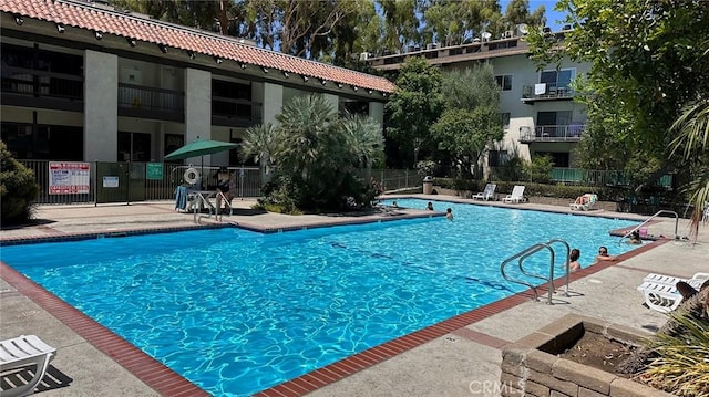 view of swimming pool featuring a patio area