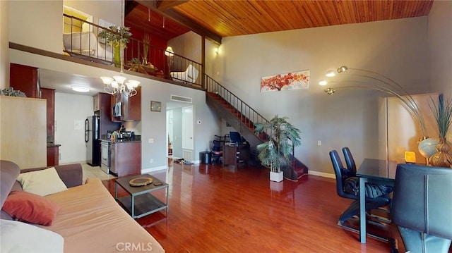 living room with wood ceiling, an inviting chandelier, wood-type flooring, high vaulted ceiling, and beam ceiling