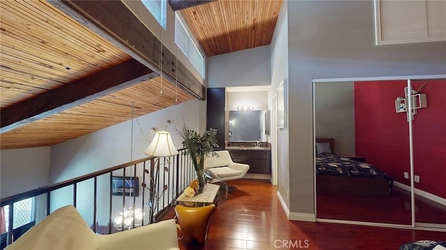 hall featuring wood ceiling, beamed ceiling, and hardwood / wood-style flooring