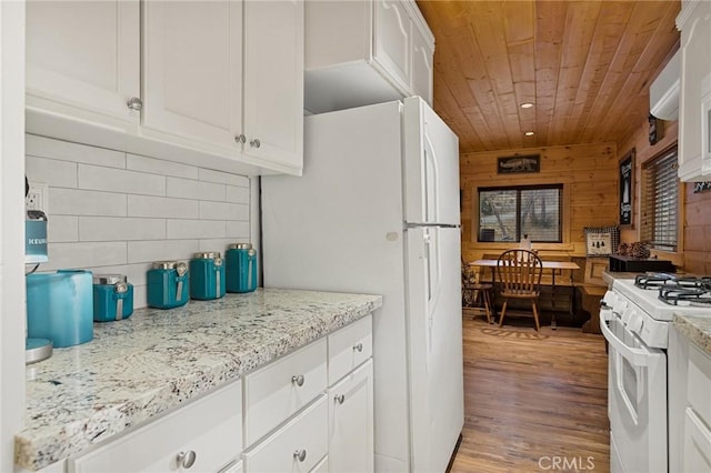 kitchen with white appliances, tasteful backsplash, wooden ceiling, and white cabinets