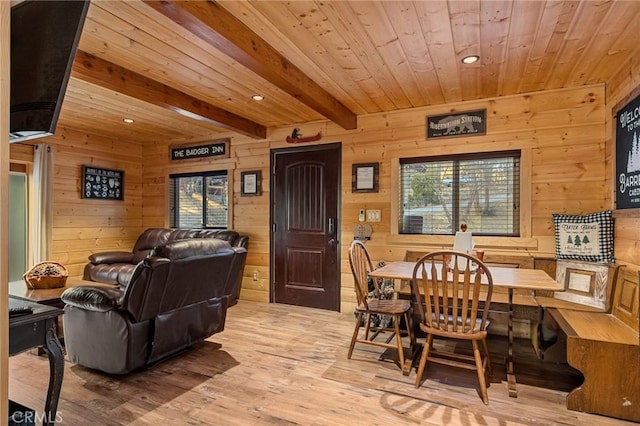 dining room with wood walls, recessed lighting, wooden ceiling, beamed ceiling, and wood finished floors