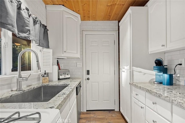 kitchen with wooden ceiling, decorative backsplash, a sink, dishwasher, and wood finished floors
