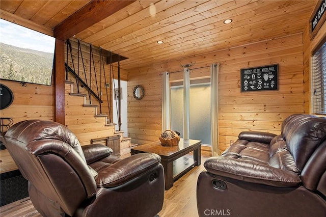 living area featuring wood ceiling, wooden walls, stairway, and wood finished floors