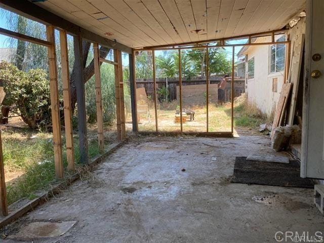 unfurnished sunroom with wood ceiling