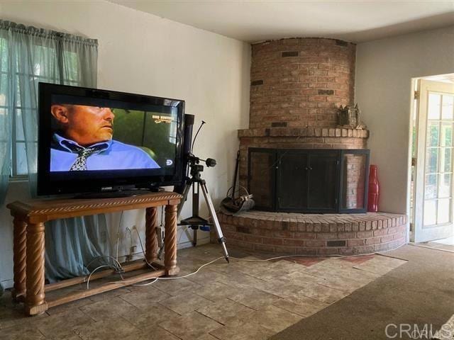 living room with a wealth of natural light and a fireplace