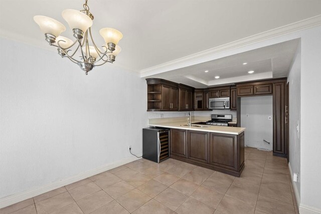 kitchen with stainless steel appliances, a raised ceiling, light countertops, hanging light fixtures, and dark brown cabinets