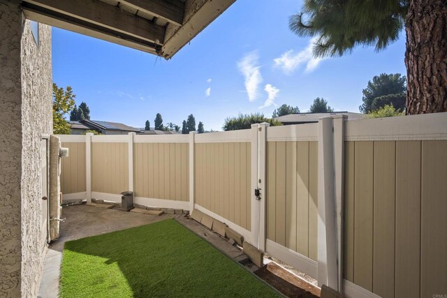 view of yard with a fenced backyard and a patio