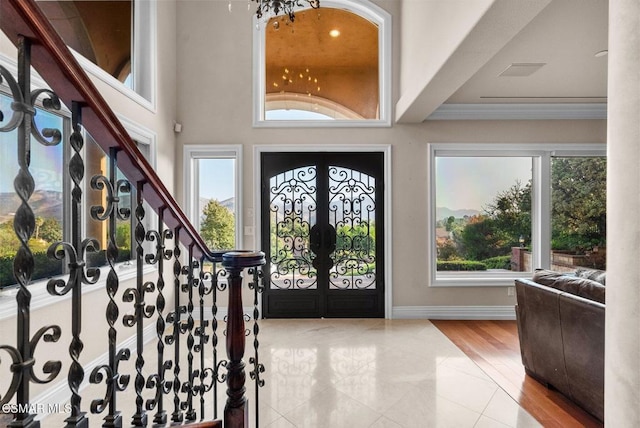 foyer featuring ornamental molding and a healthy amount of sunlight