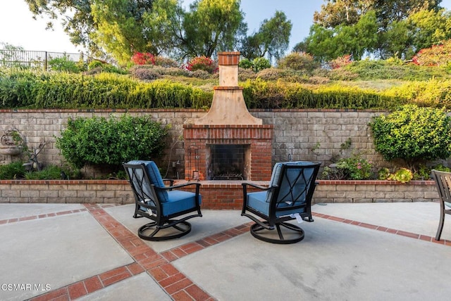 view of patio featuring an outdoor brick fireplace