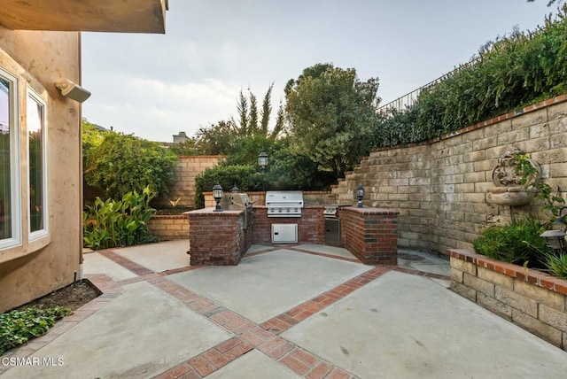 view of patio / terrace featuring area for grilling and a grill