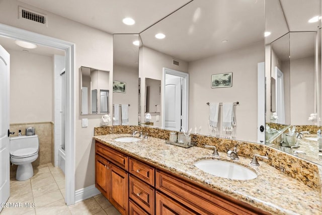 full bathroom with tile patterned floors, toilet, shower / washtub combination, and vanity