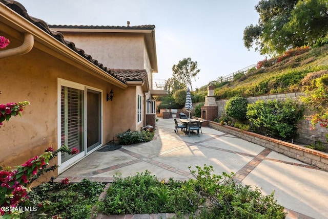 view of patio / terrace featuring a fireplace