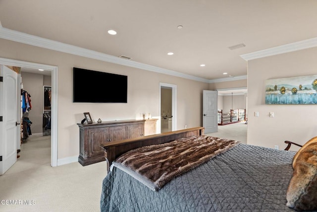 bedroom featuring crown molding, a walk in closet, and light colored carpet