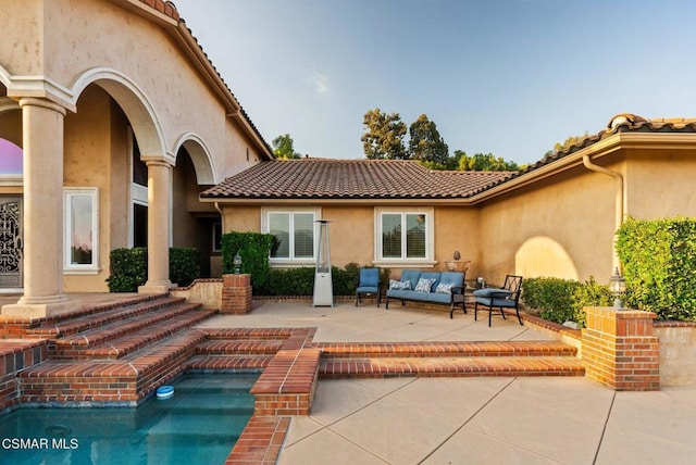 rear view of house featuring outdoor lounge area and a patio