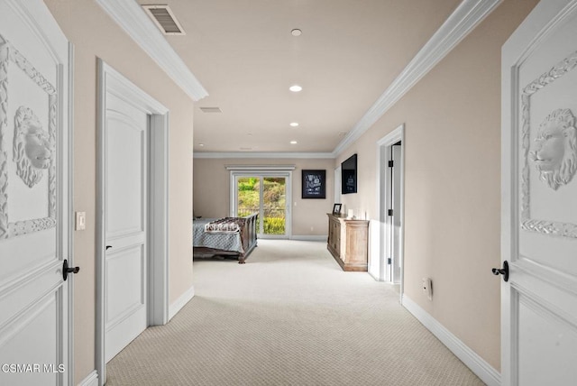 corridor with ornamental molding and light colored carpet