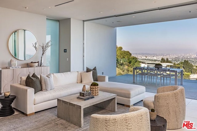 tiled living room with floor to ceiling windows