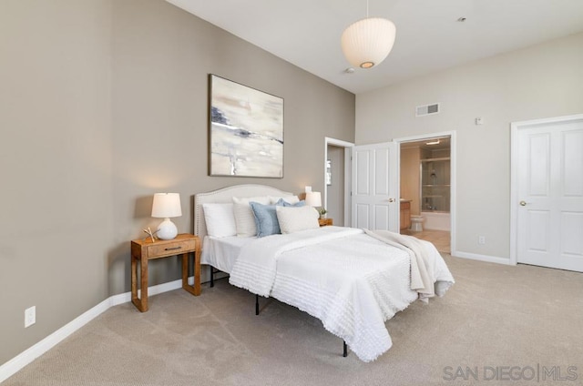 bedroom featuring carpet and ensuite bath