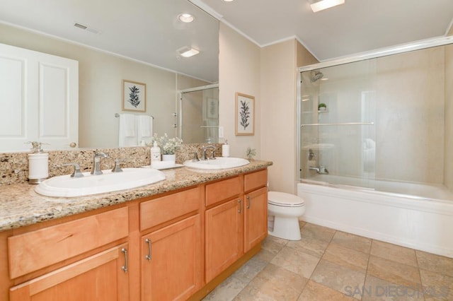 full bathroom featuring toilet, vanity, bath / shower combo with glass door, and crown molding