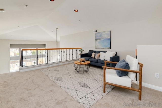 living room featuring lofted ceiling and light colored carpet