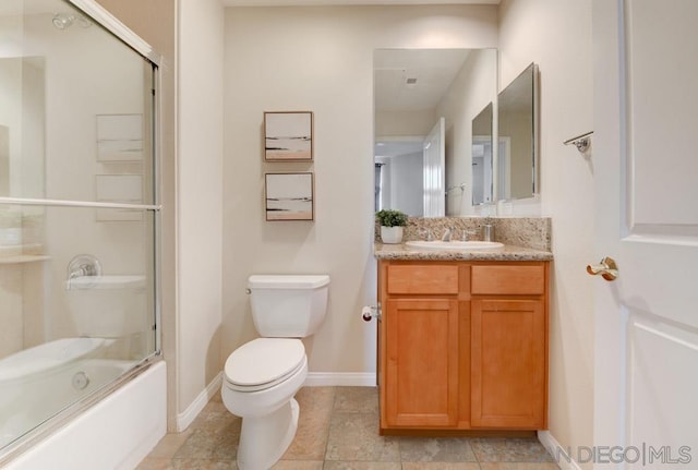 full bathroom featuring vanity, enclosed tub / shower combo, and toilet