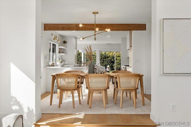 bar with pendant lighting and a chandelier