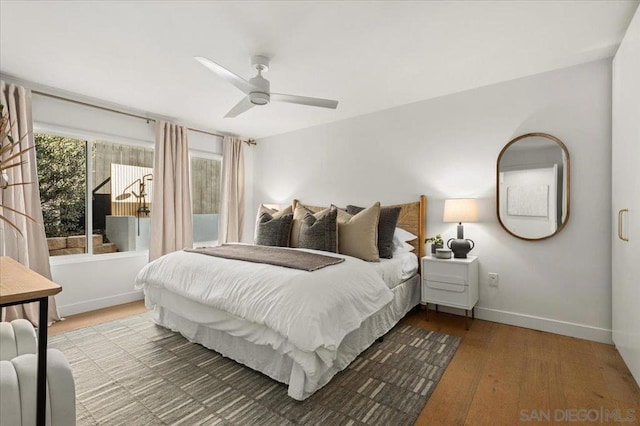 bedroom with wood-type flooring and ceiling fan