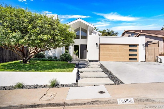 contemporary home featuring a garage and a front yard