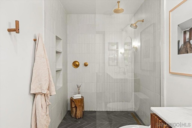 bathroom featuring vanity and tiled shower