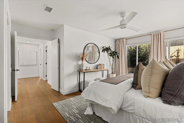 bedroom with light hardwood / wood-style floors and ceiling fan