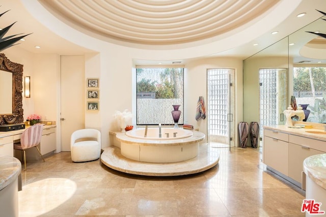 bathroom featuring vanity and a tub