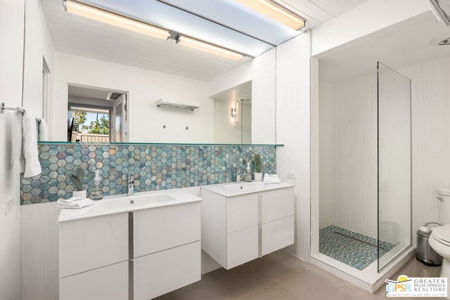 bathroom featuring tile patterned flooring, tile walls, vanity, toilet, and walk in shower