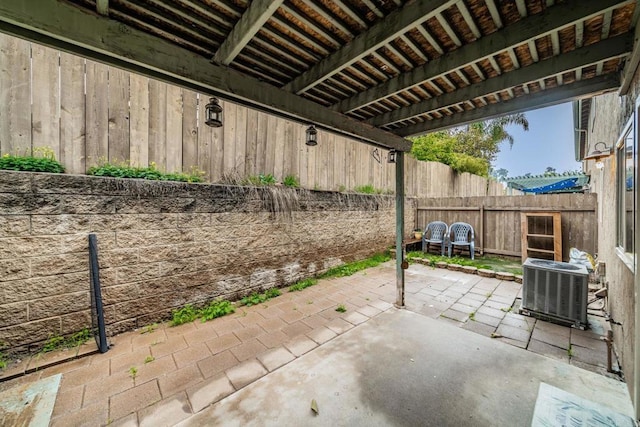 view of patio / terrace featuring fence and central AC