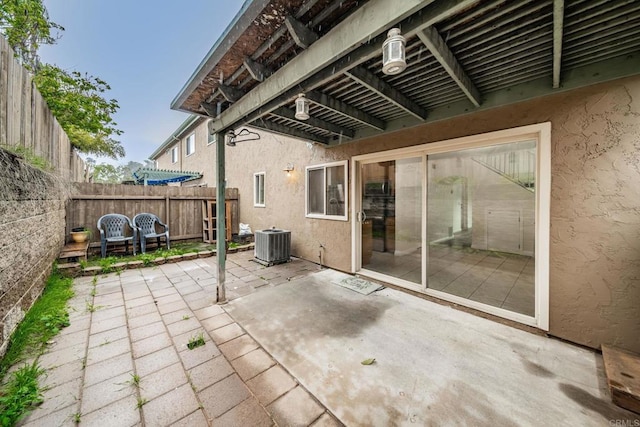view of patio / terrace with a pergola, central air condition unit, and fence