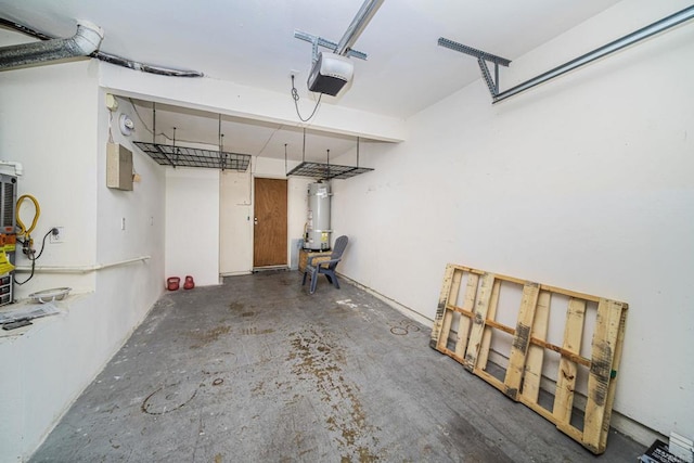 garage featuring strapped water heater and a garage door opener