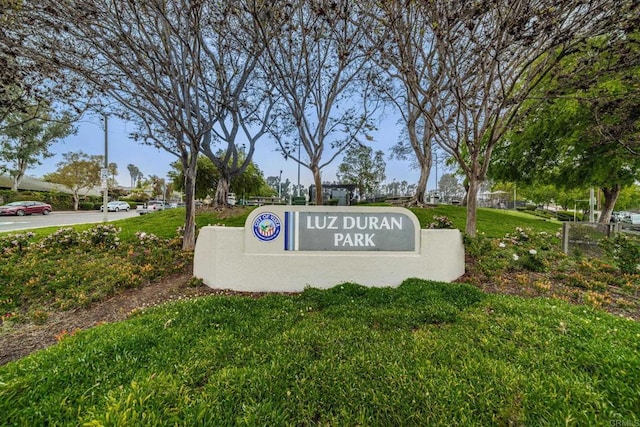 community sign featuring a lawn